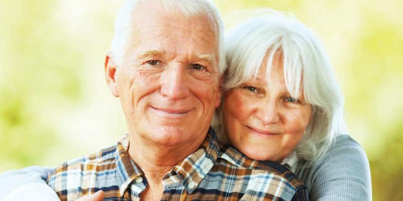 Senior couple smiling into camera