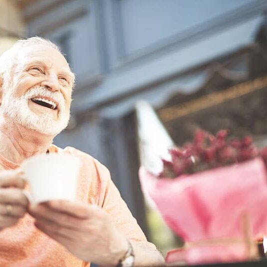 Senior man drinking coffee outside